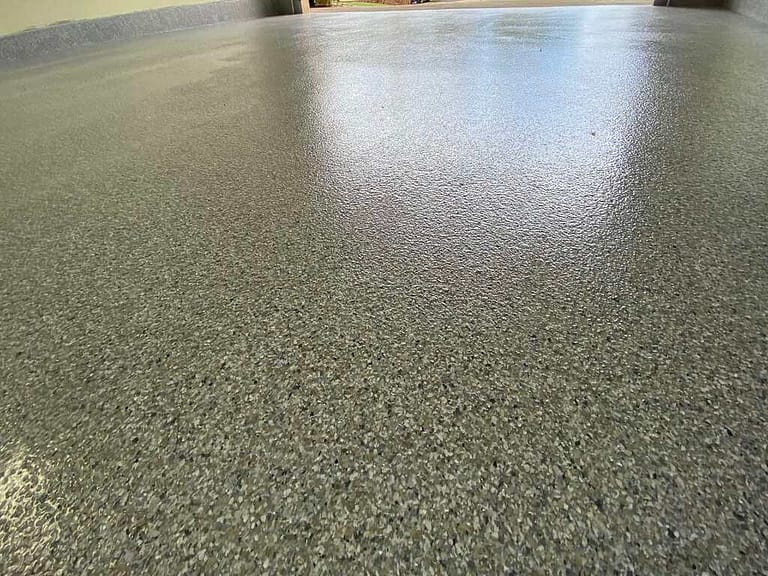 Detailed picture of the epoxy flakes on a 2 car garage.